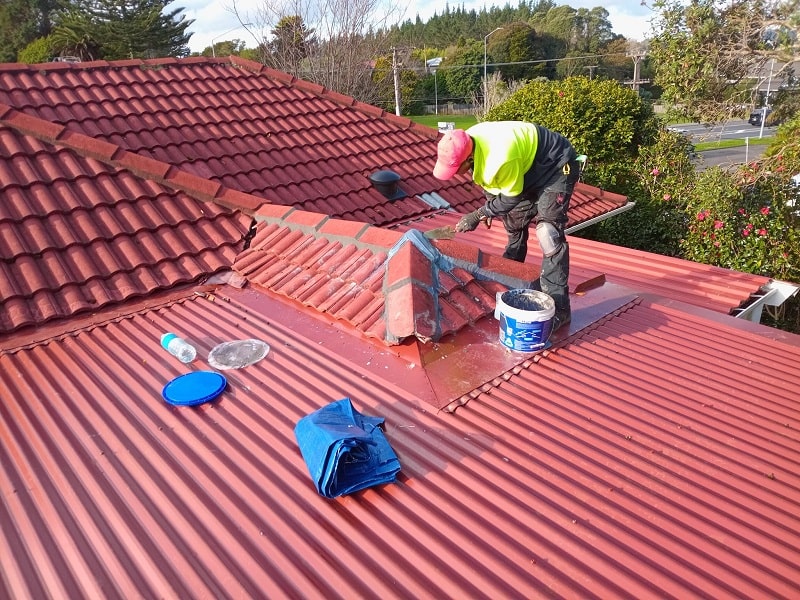 Roofer repairing a roof in New Zealand