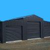 Black metal garage with three roller doors