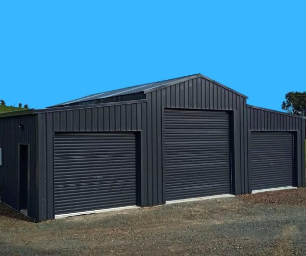 Black metal garage with three roller doors