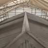 Industrial corrugated metal roof under a protective scaffolding structure